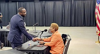 Hughes Mayor Lincoln Barnett thanks Pine Bluff Mayor Shirley Washington for transferring police units for the city of Hughes and Wabbaseka's police department. (Pine Bluff Commercial/Eplunus Colvin)